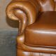 Small Chesterfield leather sofa with a high back.