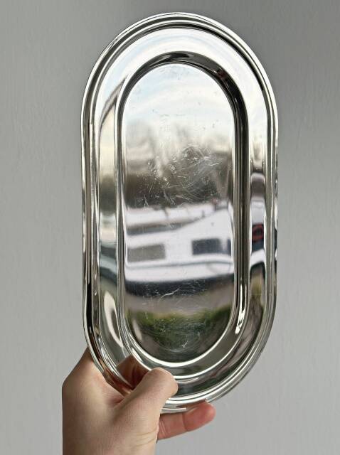 Small antique tray made of lightweight metal.