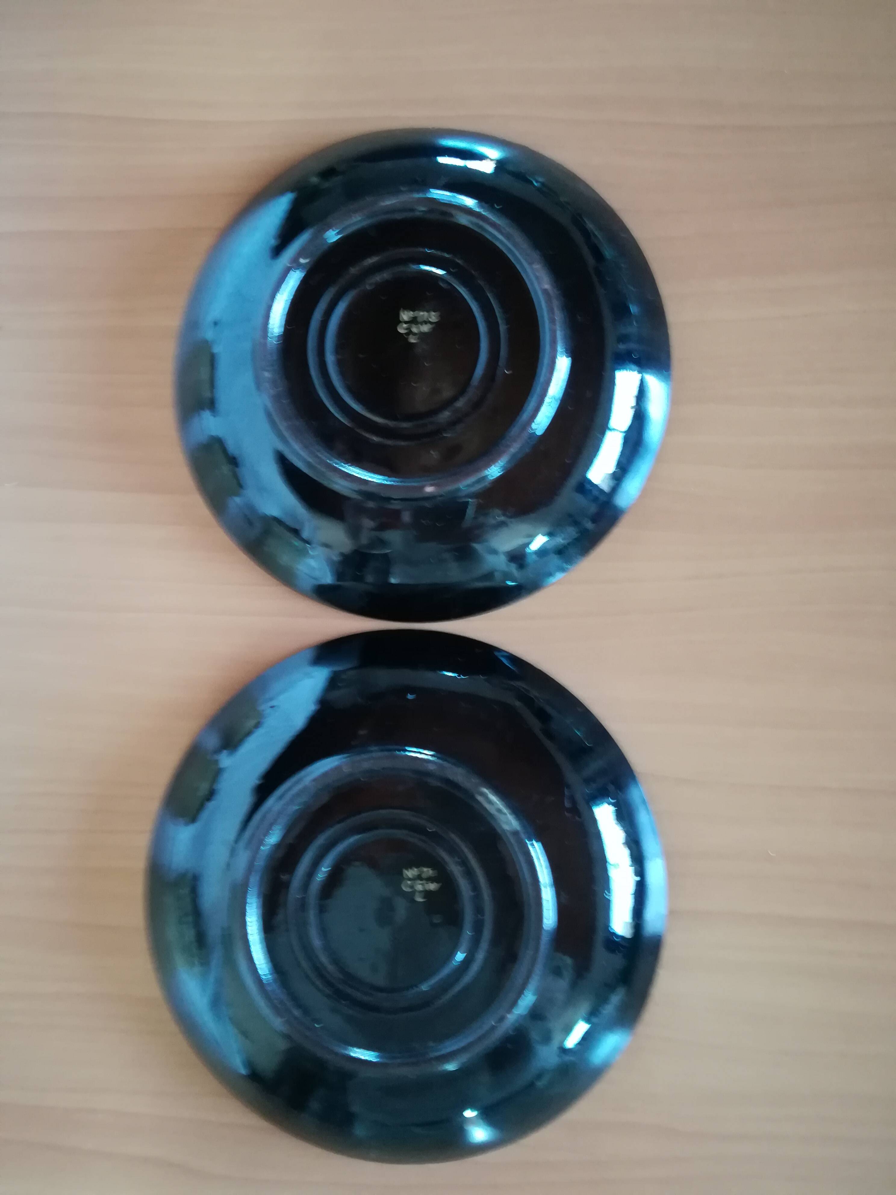 Black cups and saucers with relief decoration