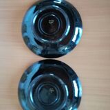 Black cups and saucers with relief decoration