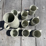 Set in stoneware cups and pitcher