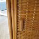 Storage column, wooden bookshelf and woven rattan.