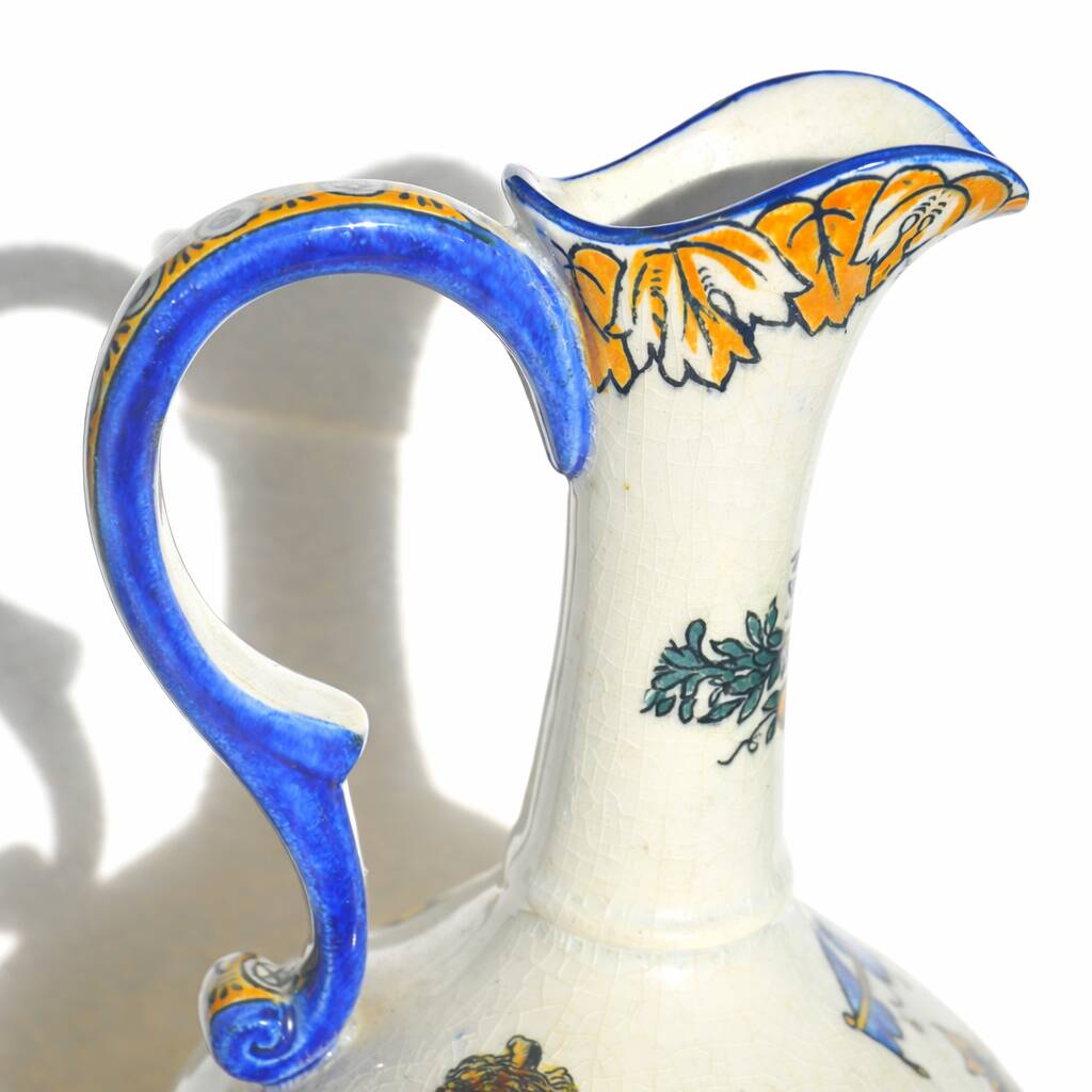 Gien earthenware jug, Renaissance decoration, putto with dolphin.
