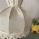 Small vintage wooden turned table lamp with a pleated shade.