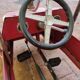 Old pedal car in tole fire truck