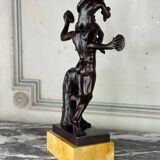 Dionysus on the shoulders of a satyr, bronze after the antique on a yellow Siena base.