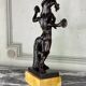 Dionysus on the shoulders of a satyr, bronze after the antique on a yellow Siena base.