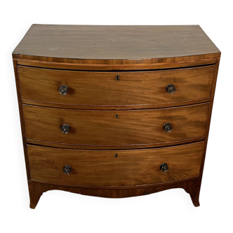 English commode from the George III Regency period, bombe shape in mahogany veneer.