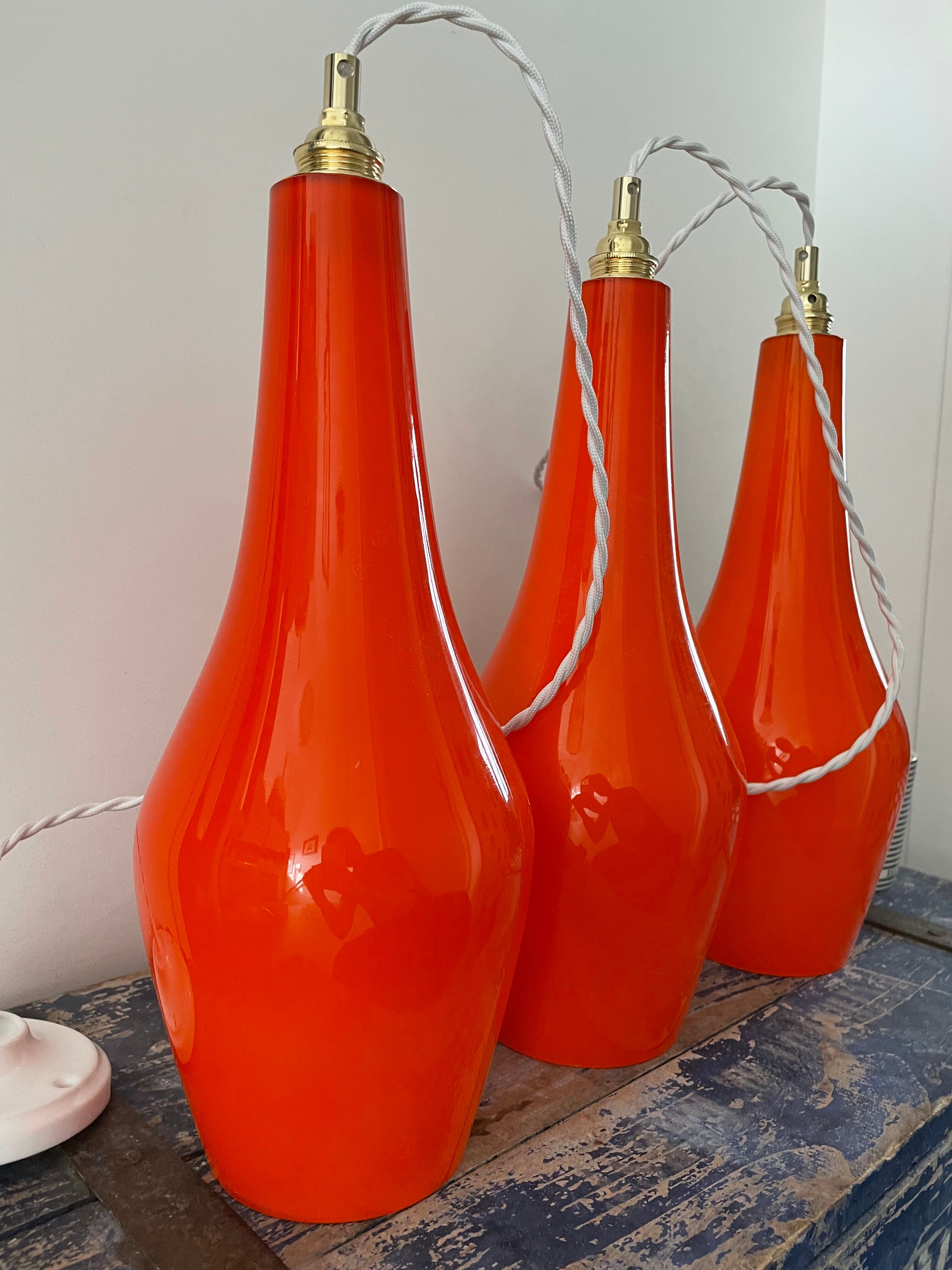 Set of three new electrified orange vintage pendant lamps