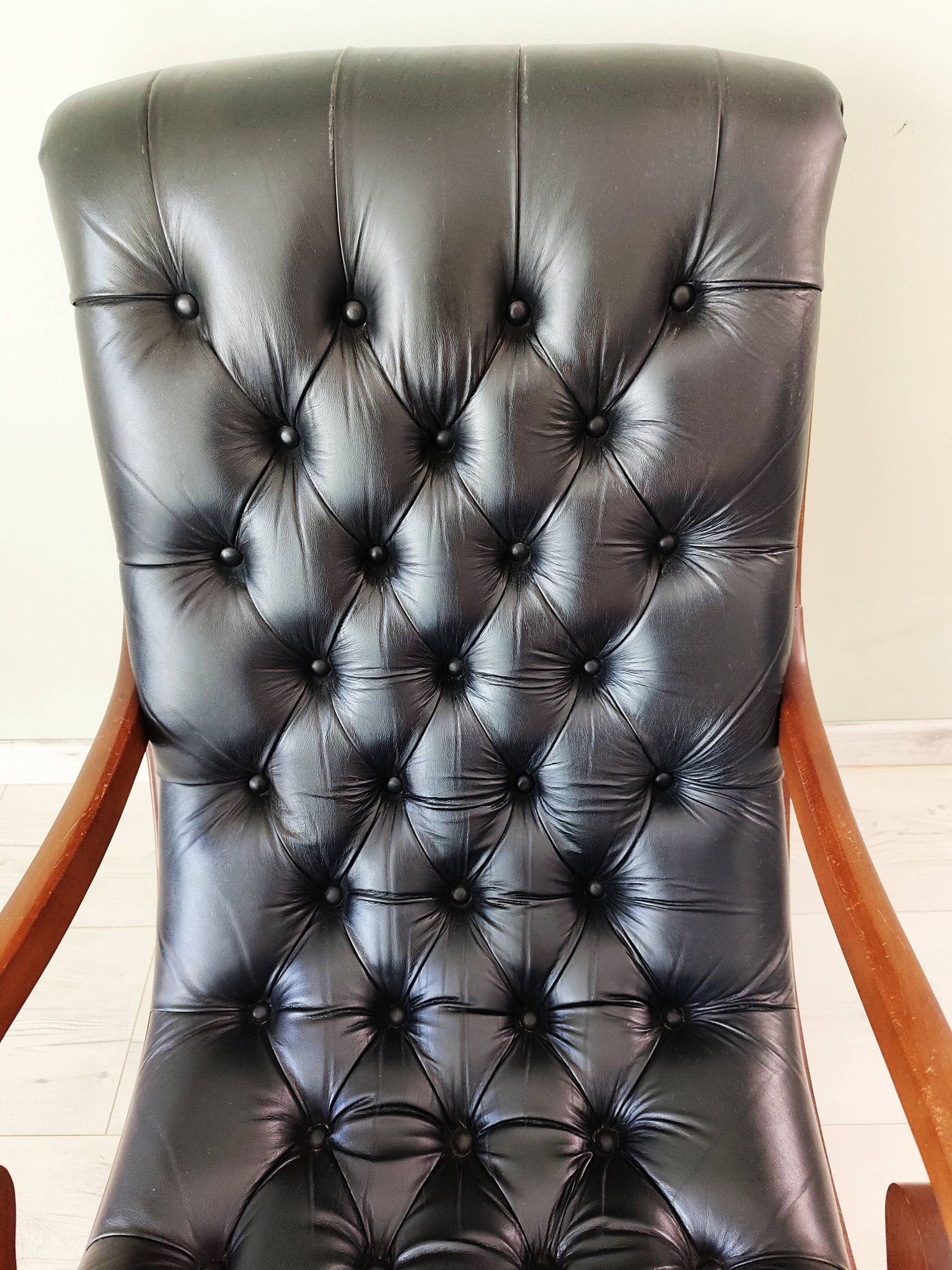 Black leather rocking Chesterfield armchair