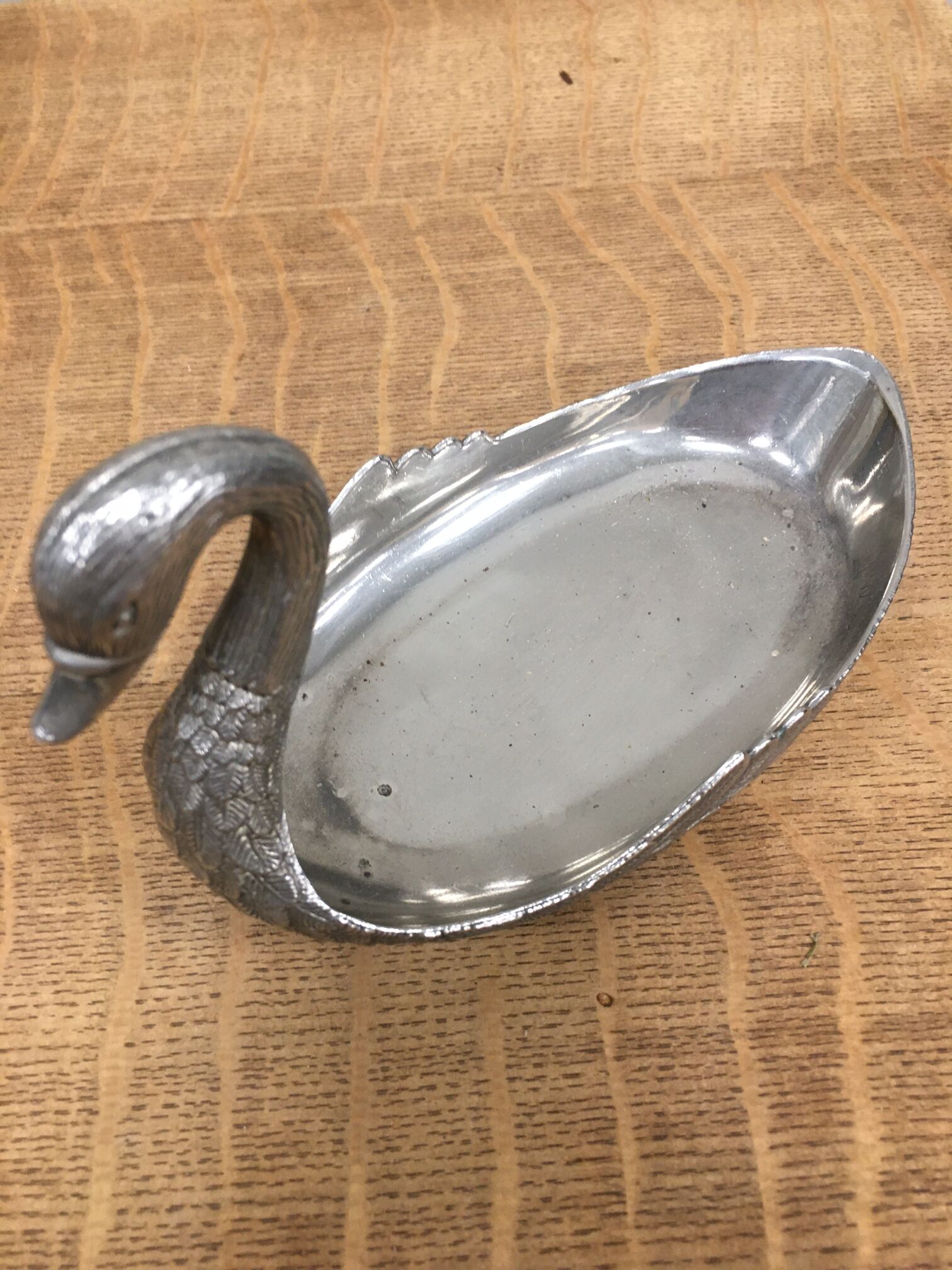 Empty silver metal swan pocket