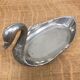 Empty silver metal swan pocket