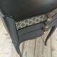 Bedside or nightstand painted black with patterns