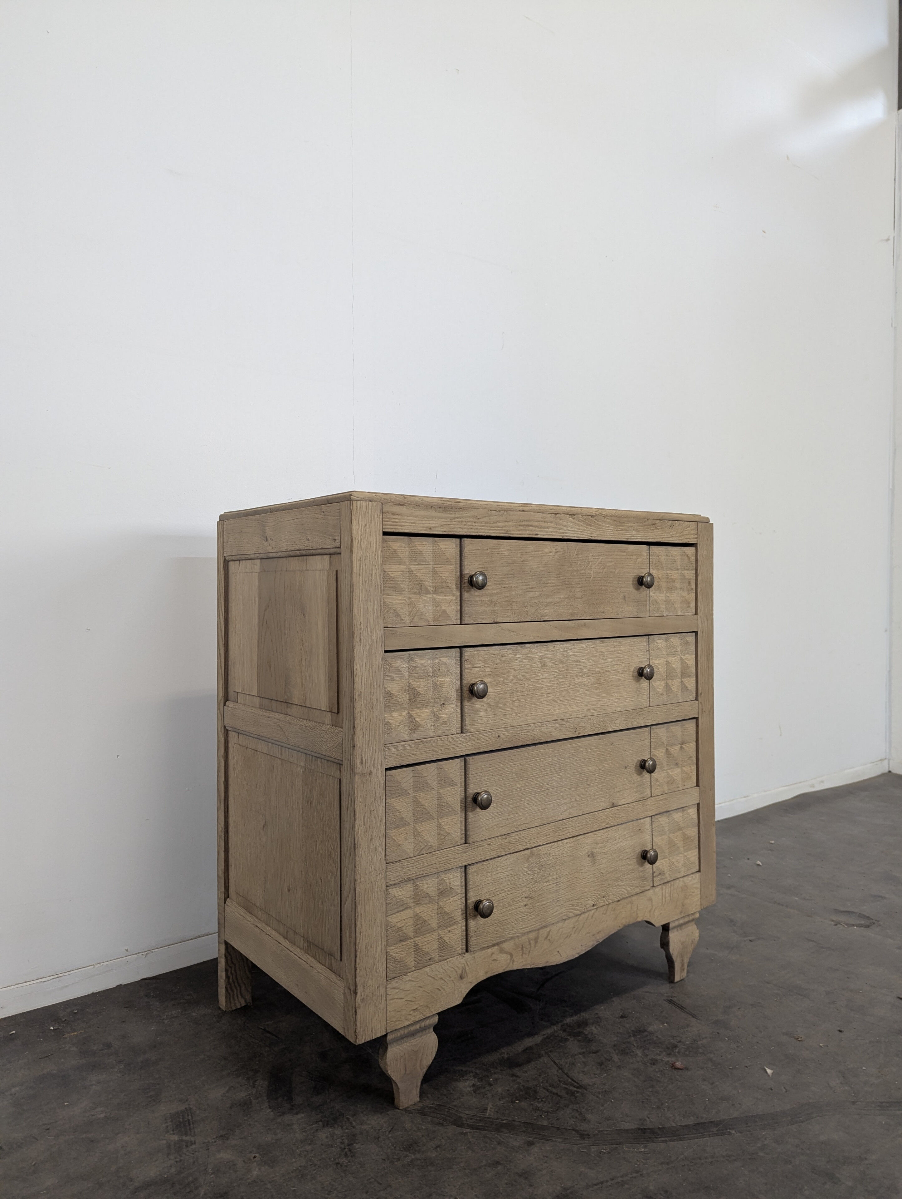 Brutalist commode with stripped diamond tips.