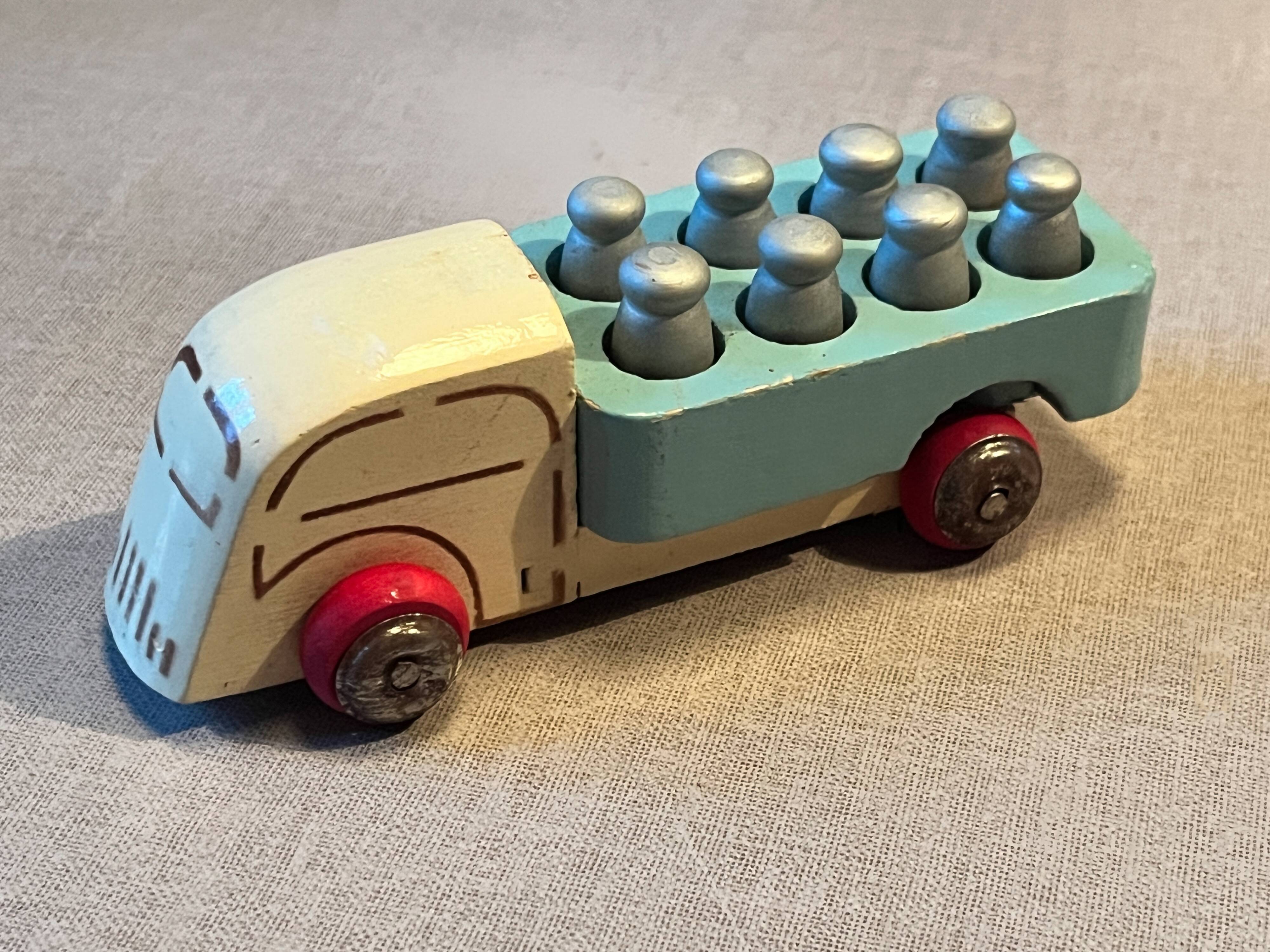 Small wooden milk truck with its cans, antique toy