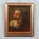 Old painting of a male face in oil on cardboard from the 19th century.
