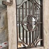 Chiseled teak door with openwork wrought iron panels