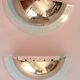Pair of gold metal and plexiglass wall lights, circa 1980.