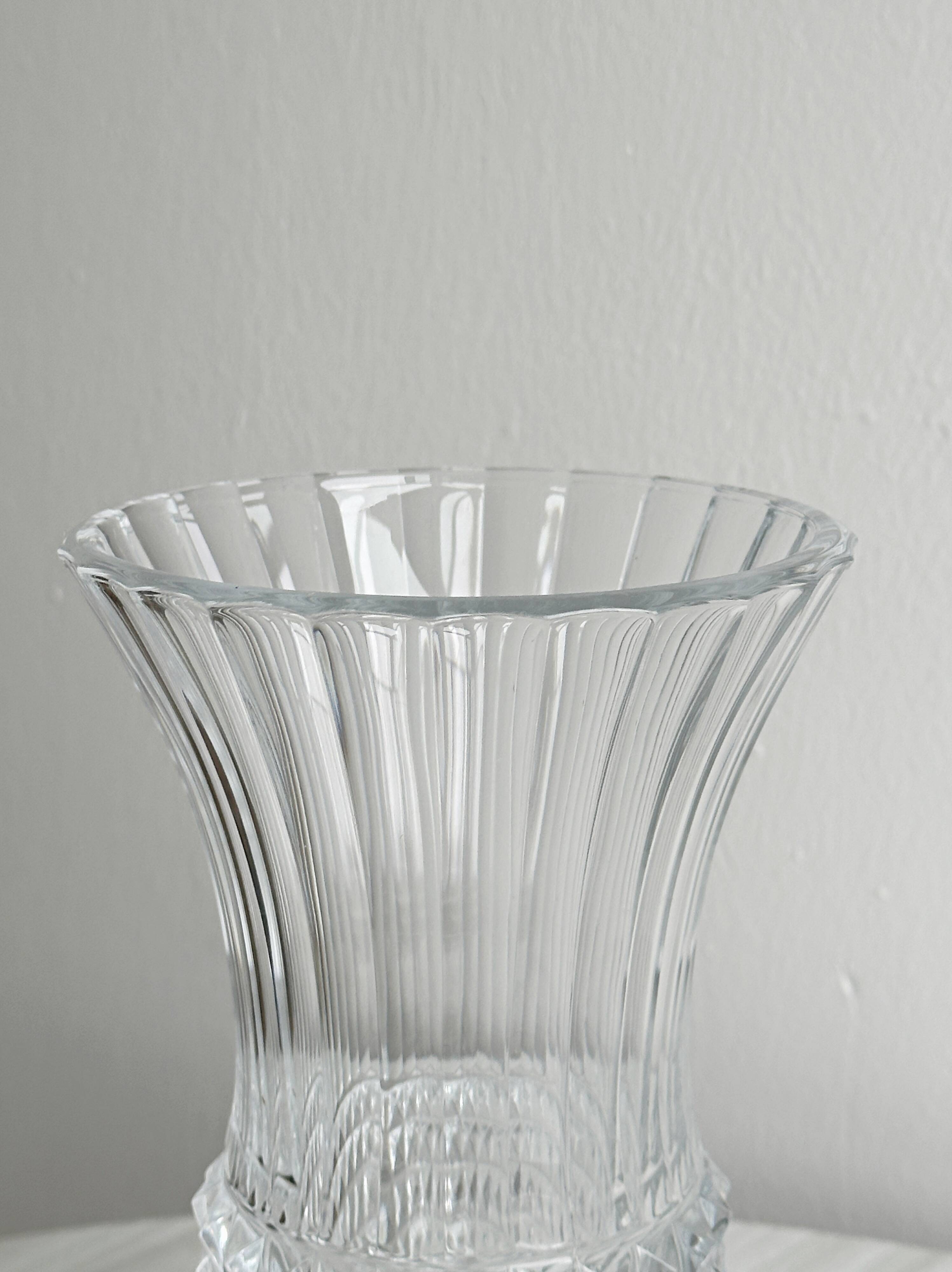 Antique thick glass vase on a pedestal.