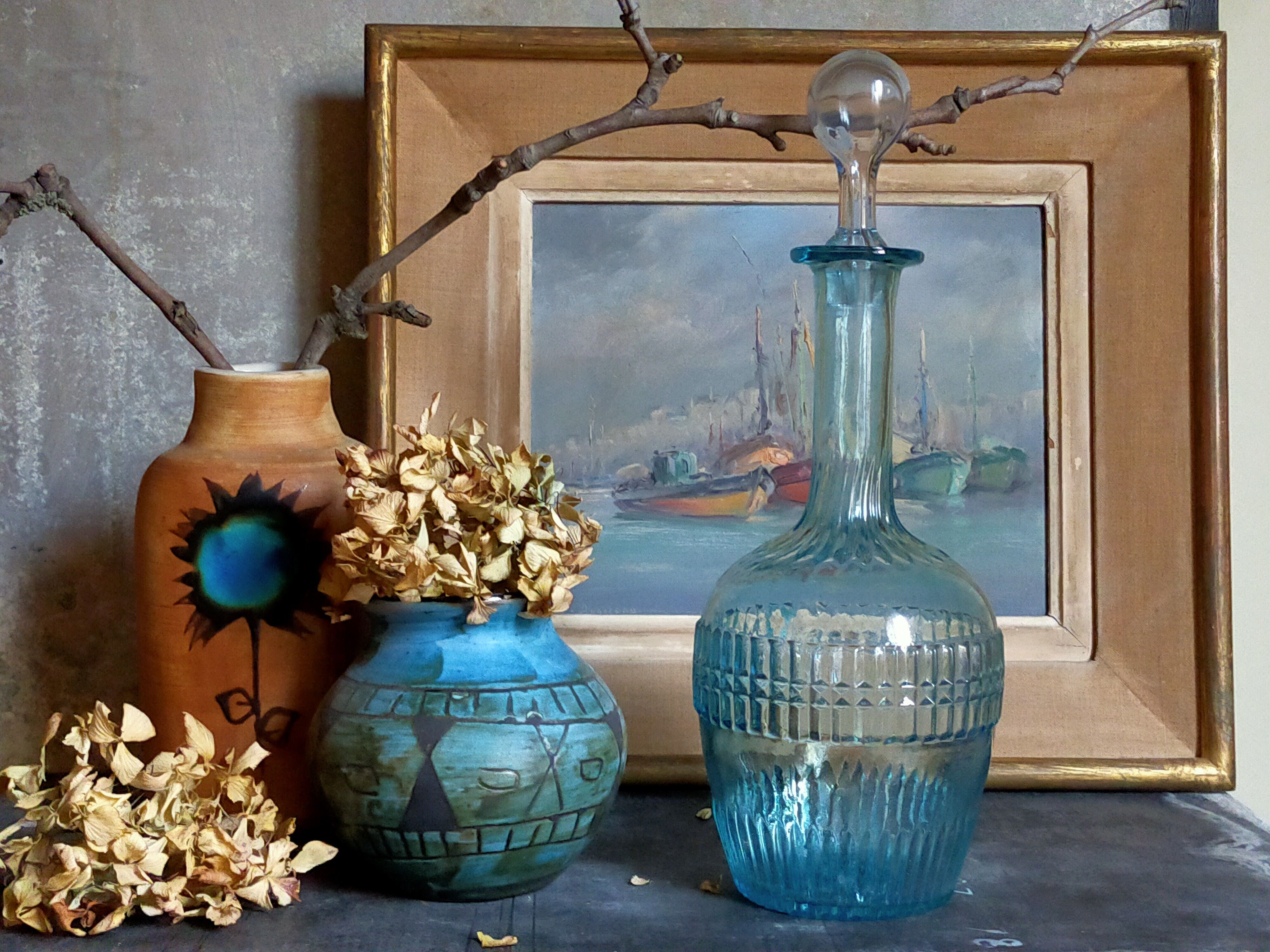 Blue glass carafe with vintage pegs