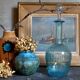 Blue glass carafe with vintage pegs