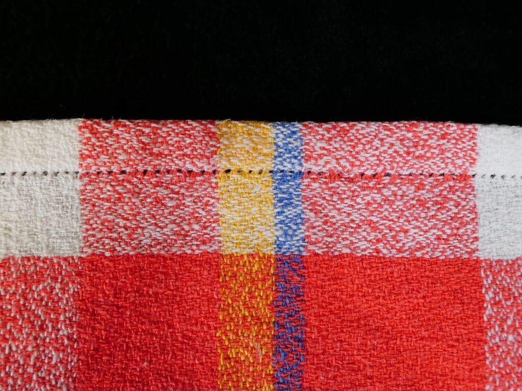 Old tablecloth and 11 towels crossed red blue