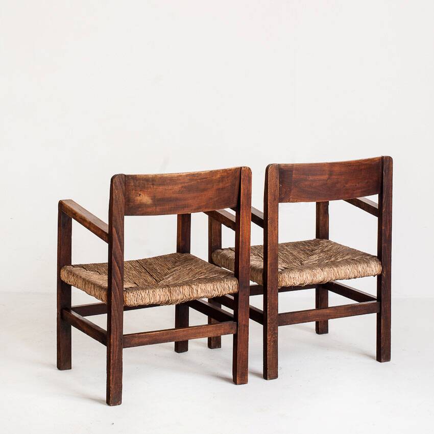 Pair of rustic armchairs in solid wood and straw seats. France, 1940s