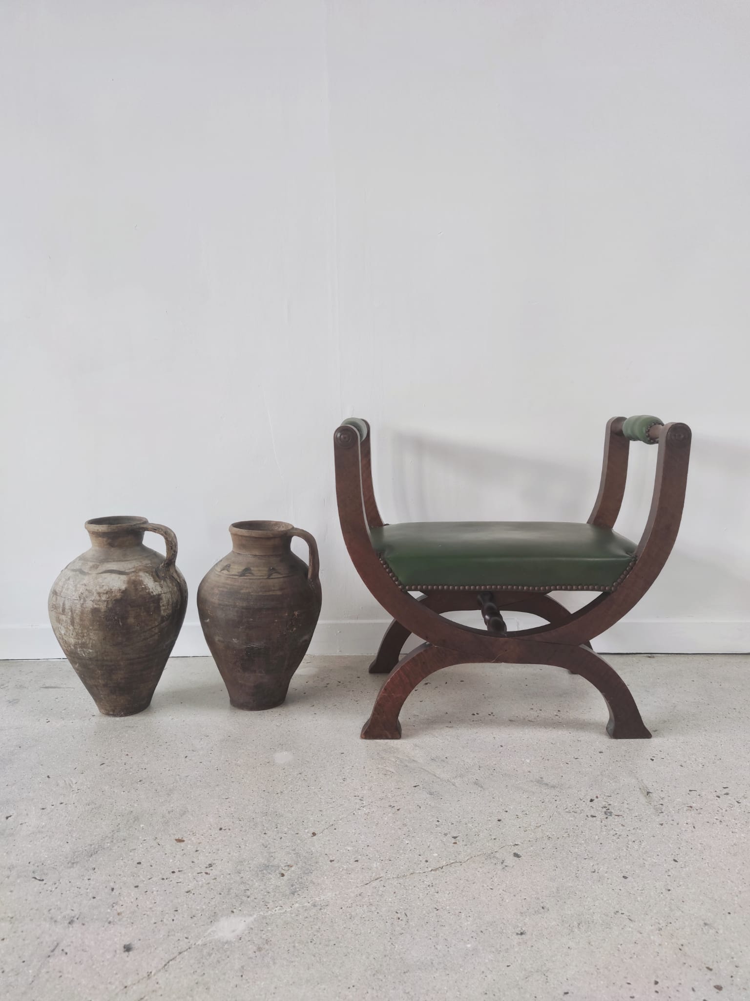 Green curule armchair
