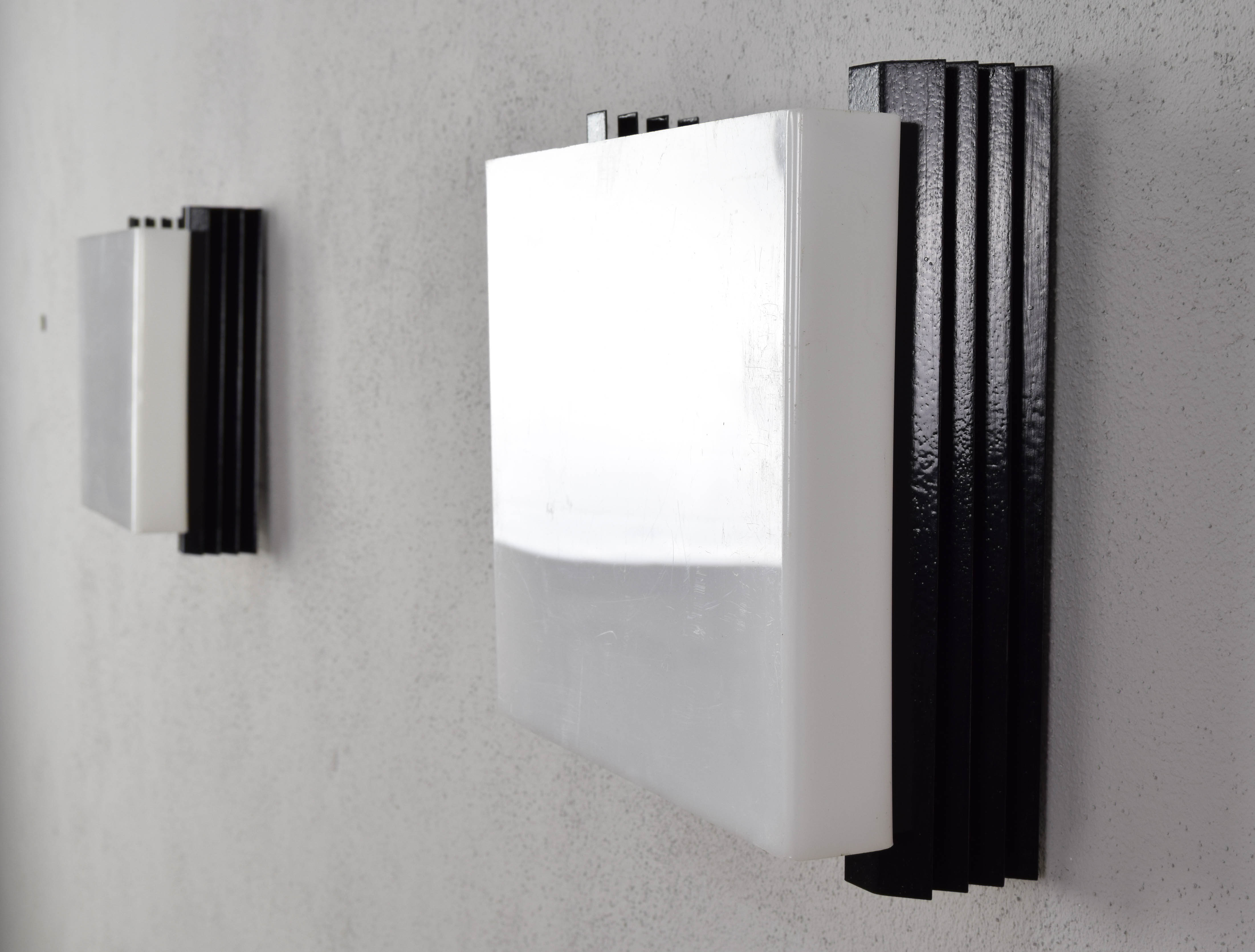 Mid-century modern sconces of black iron sheets and white lucite spain 1960s