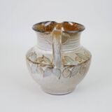Glazed ceramic jug with plant decoration