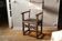 Fauteuil à bras ancien en noyer et cuir clouté, XVIIème siècle