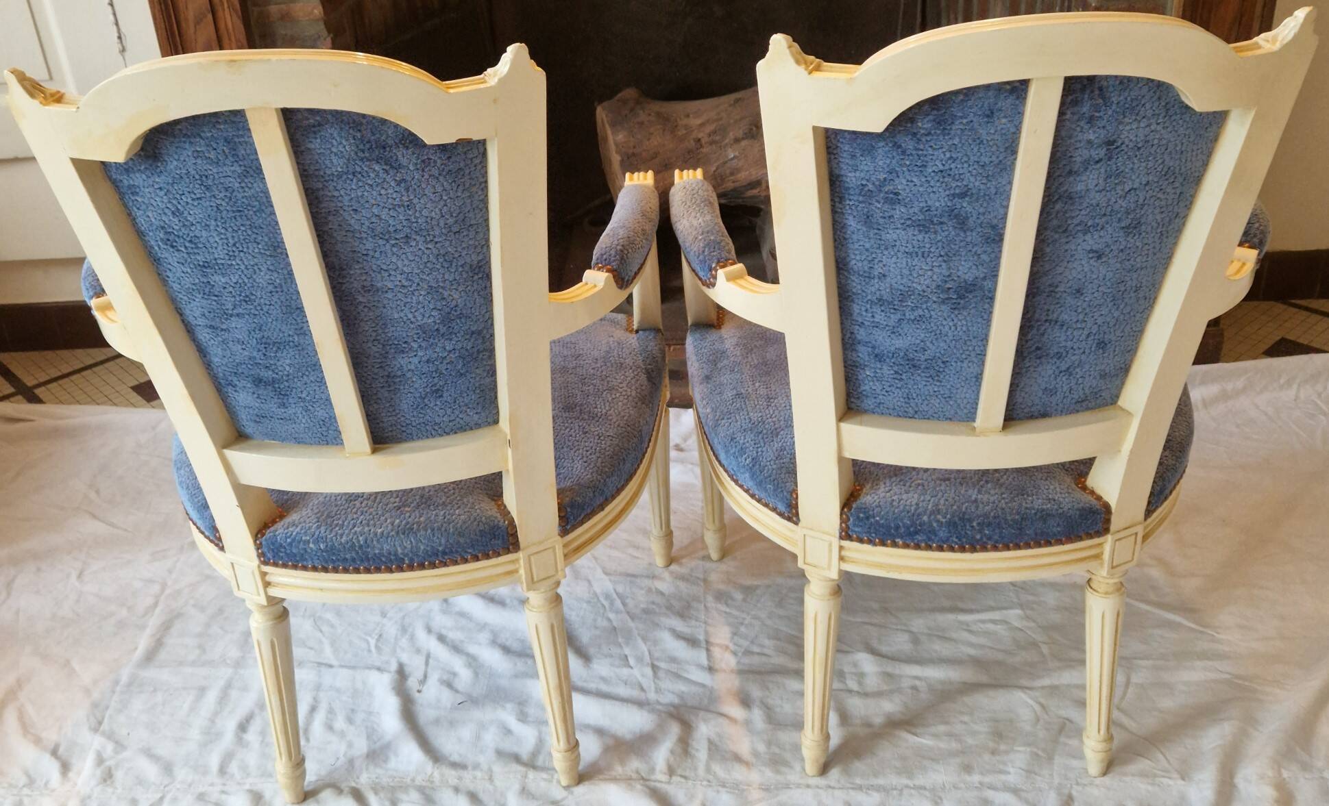 Pair of Louis XVI cabriolet armchairs in cream and blue French elegance late 19th century