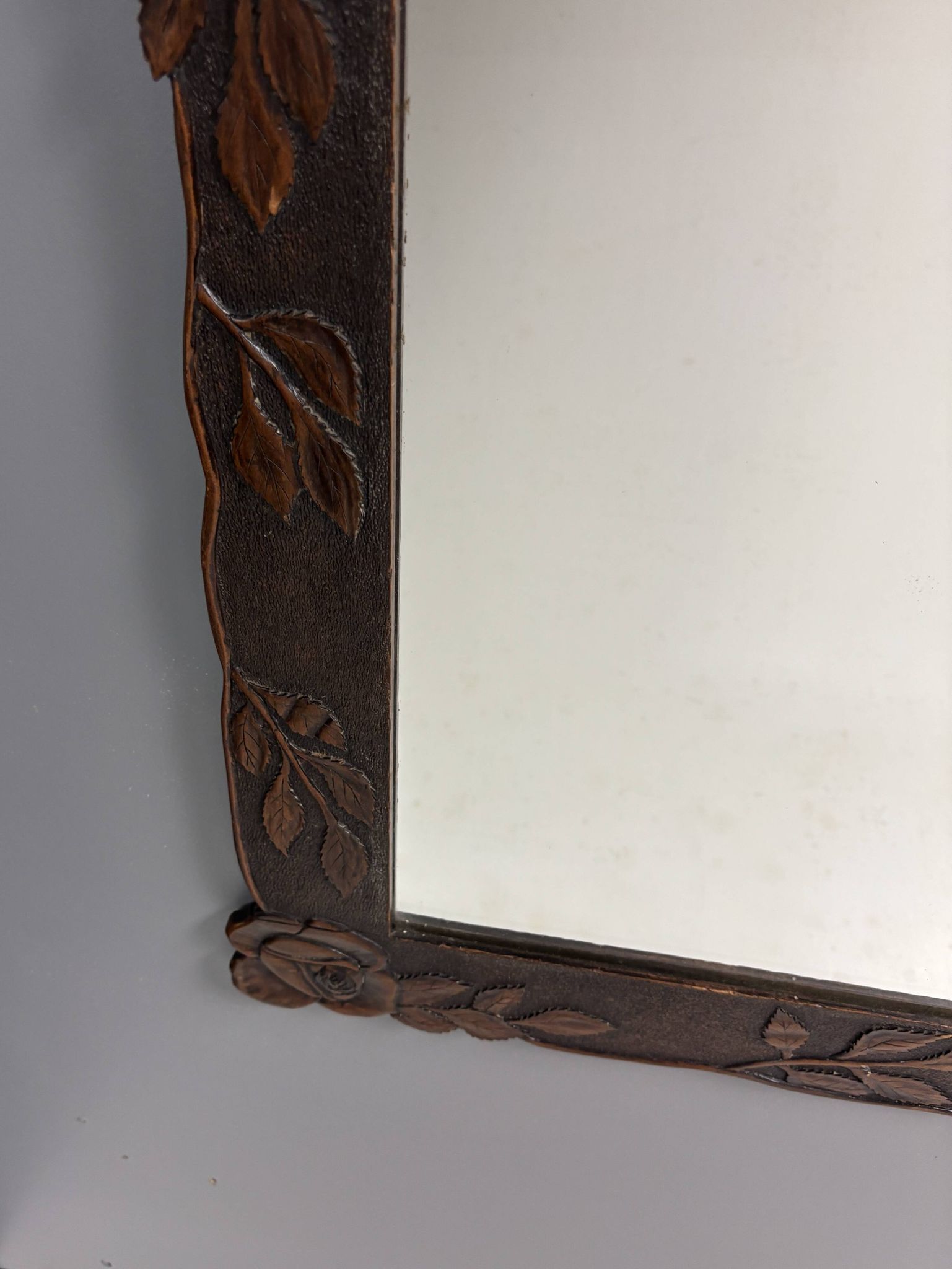 Arts & Crafts hand-carved wall mirror with floral roses, early 20th century