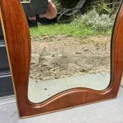 Mid-century organic shaped bevelled mirror in wooden frame, 1940s-50s