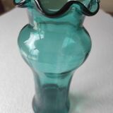 Blown glass vase with a flared neck and wavy rim.