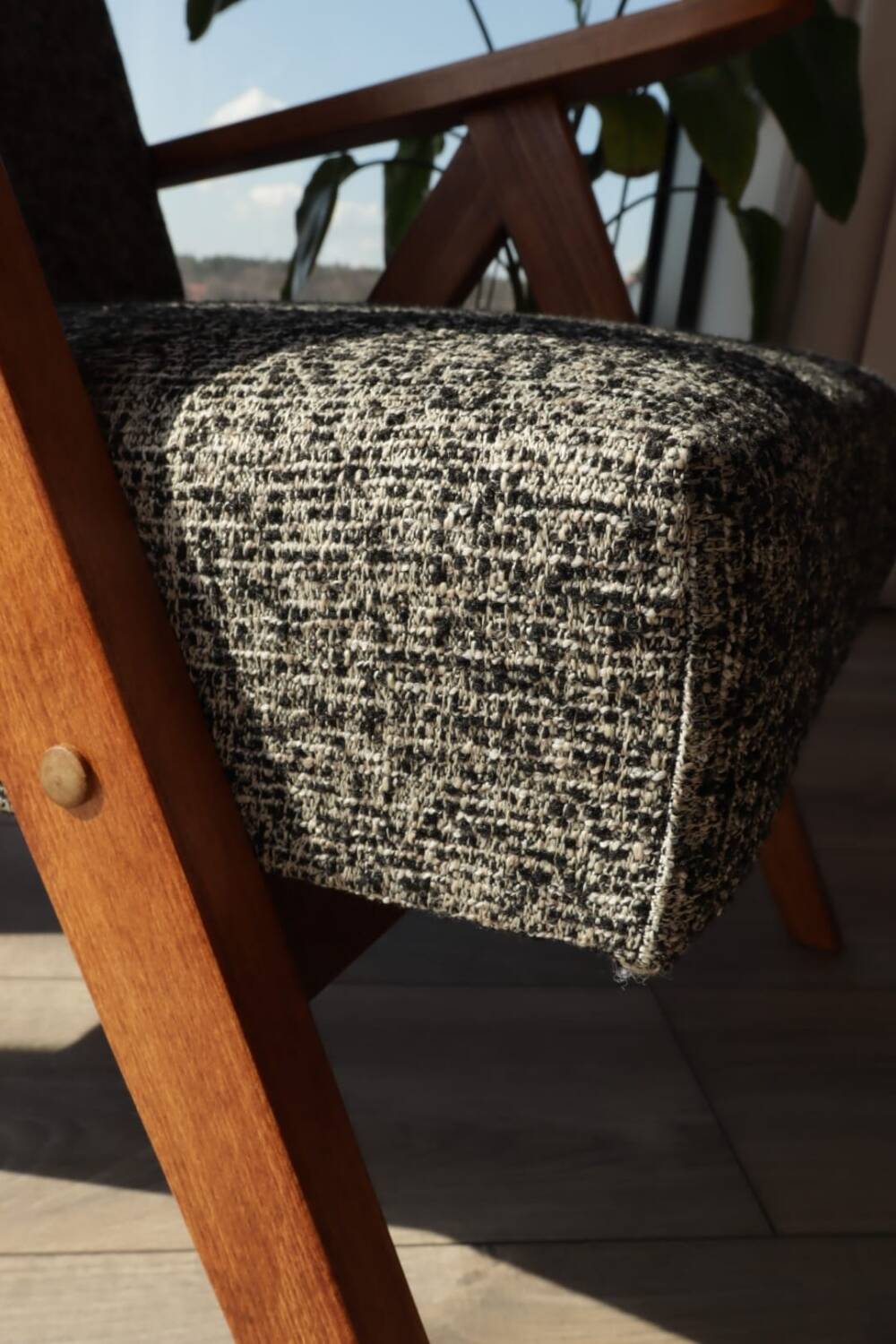 Vintage design armchair in mixed black fabric, walnut-coloured wood.