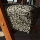 Vintage design armchair in mixed black fabric, walnut-coloured wood.