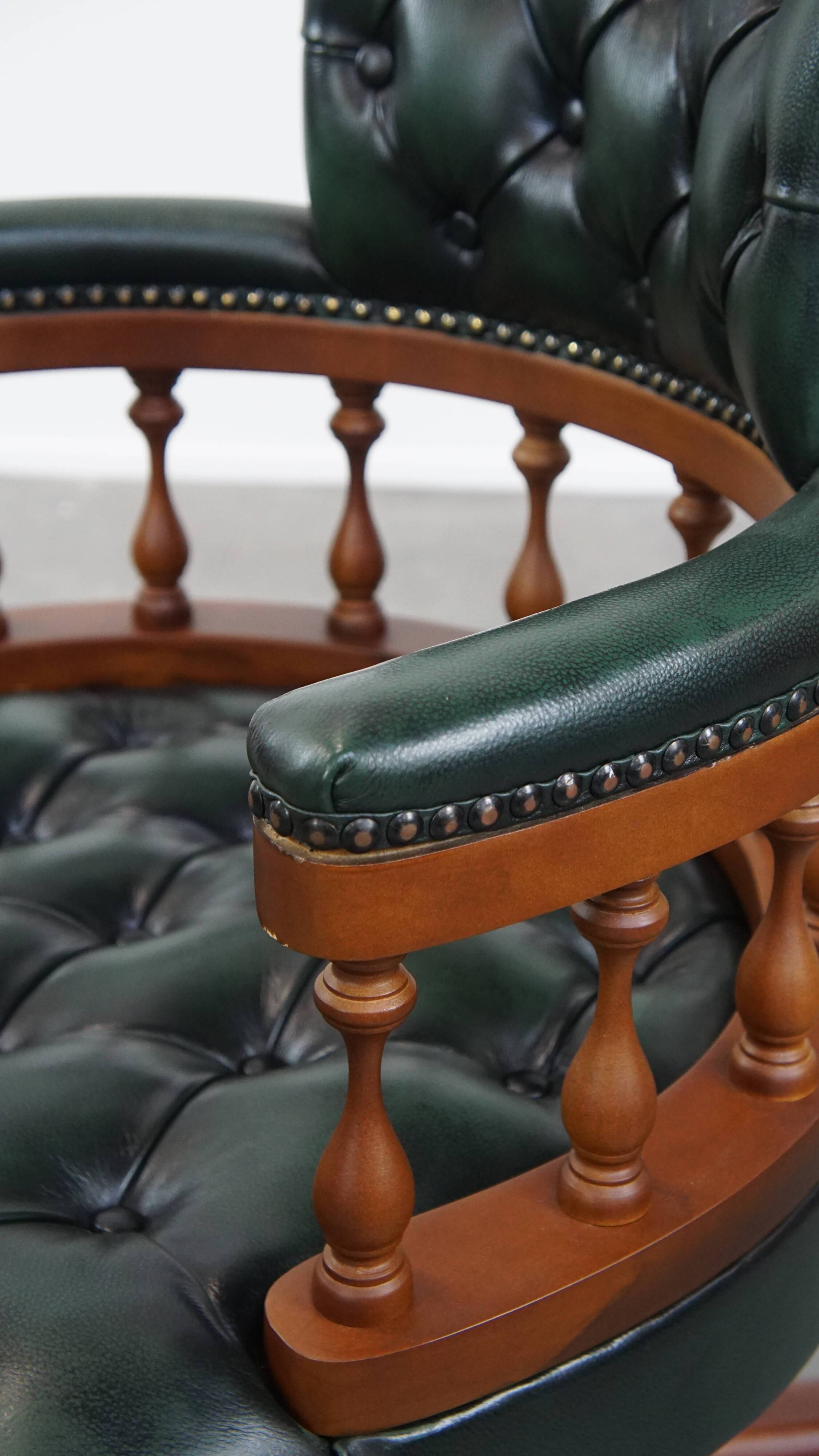 Dark green chesterfield office chair in cowhide leather on wheels