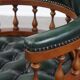 Dark green leather Chesterfield office chair on wheels.