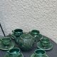 Service to the ceramic enamelled chiseled green and vintage