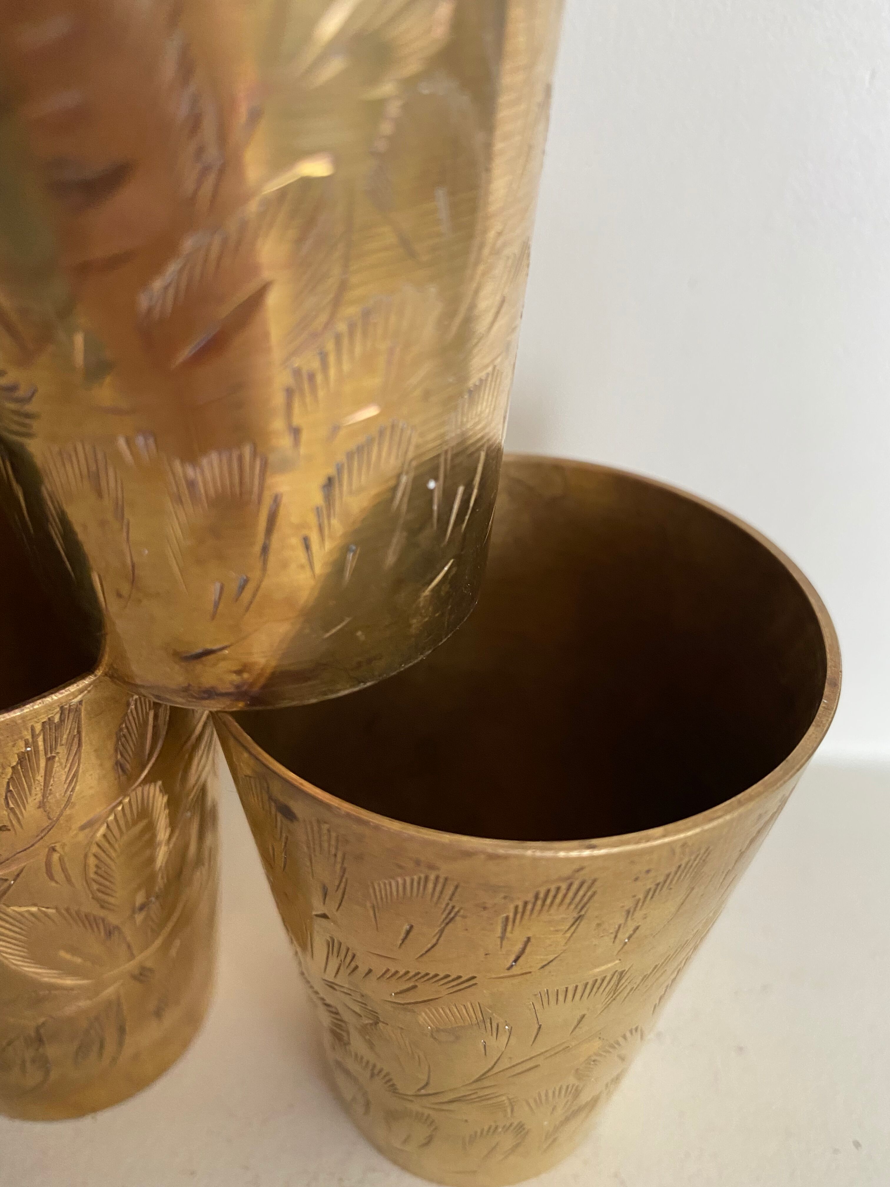 Six chiseled metal glasses