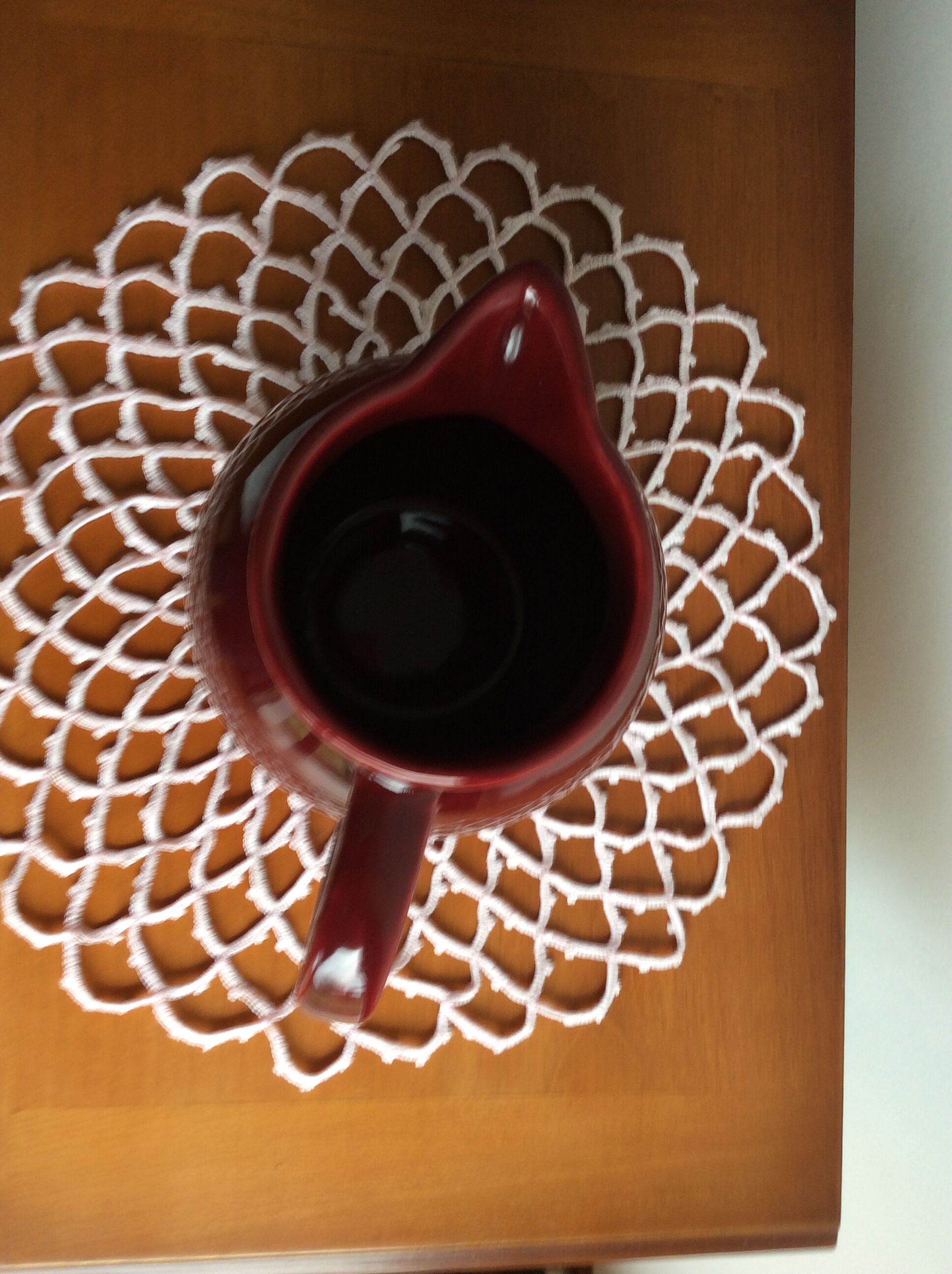 Old dark red ceramic pitcher jug