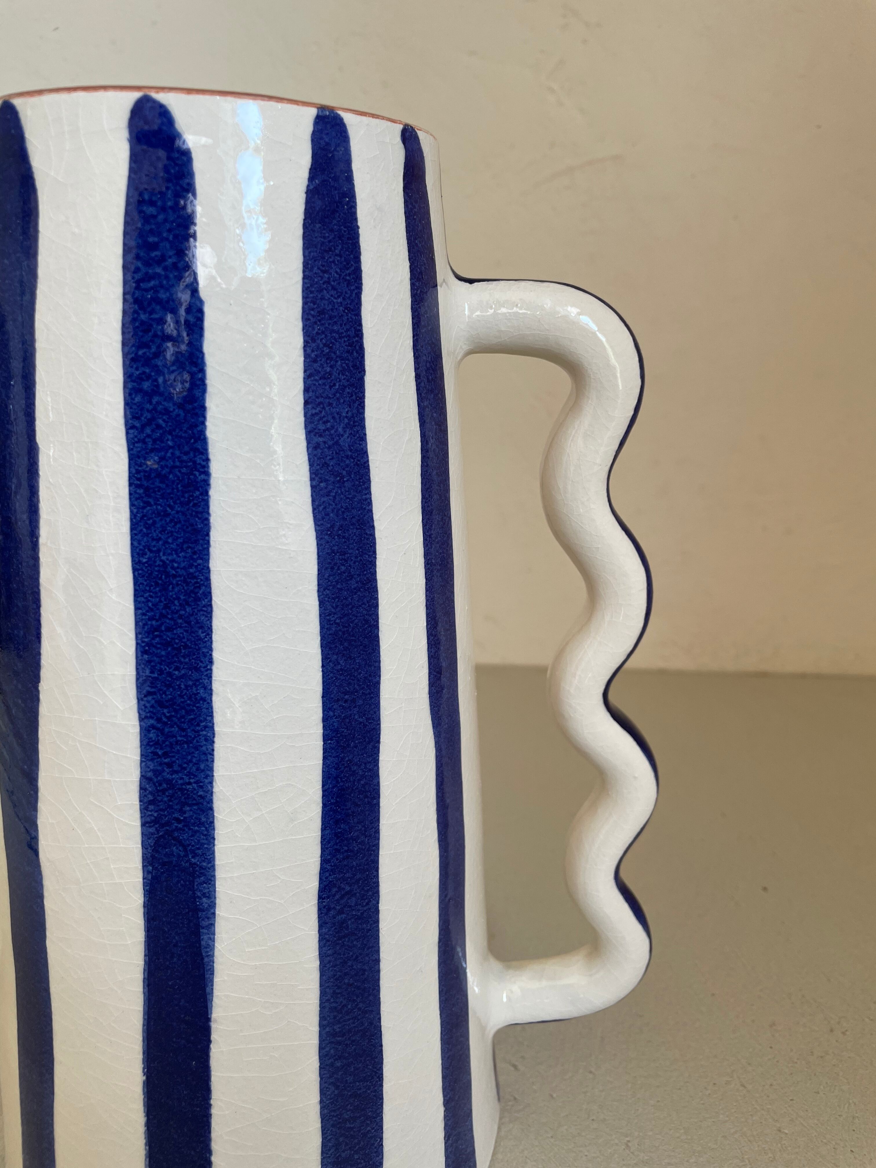 Klein blue and white striped ceramic vase with abstract handmade wavy handles