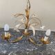 Golden metal chandelier decorated with flowers