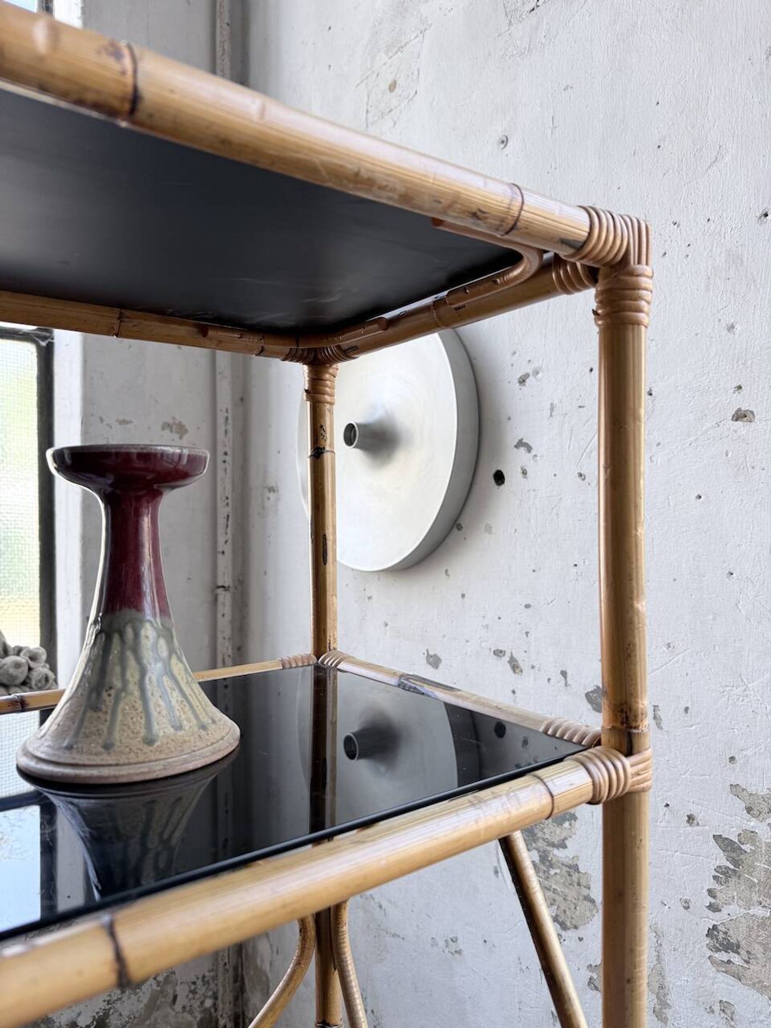 Rattan bookshelf and black glasses