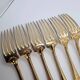 12 Table Forks in gold metal