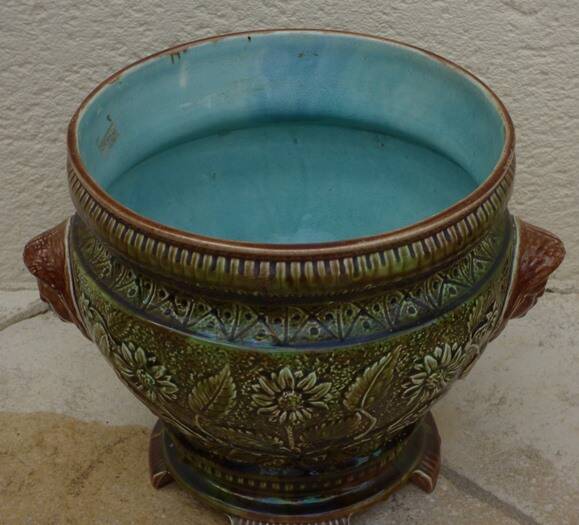 Old earthenware cachepot with woman decoration