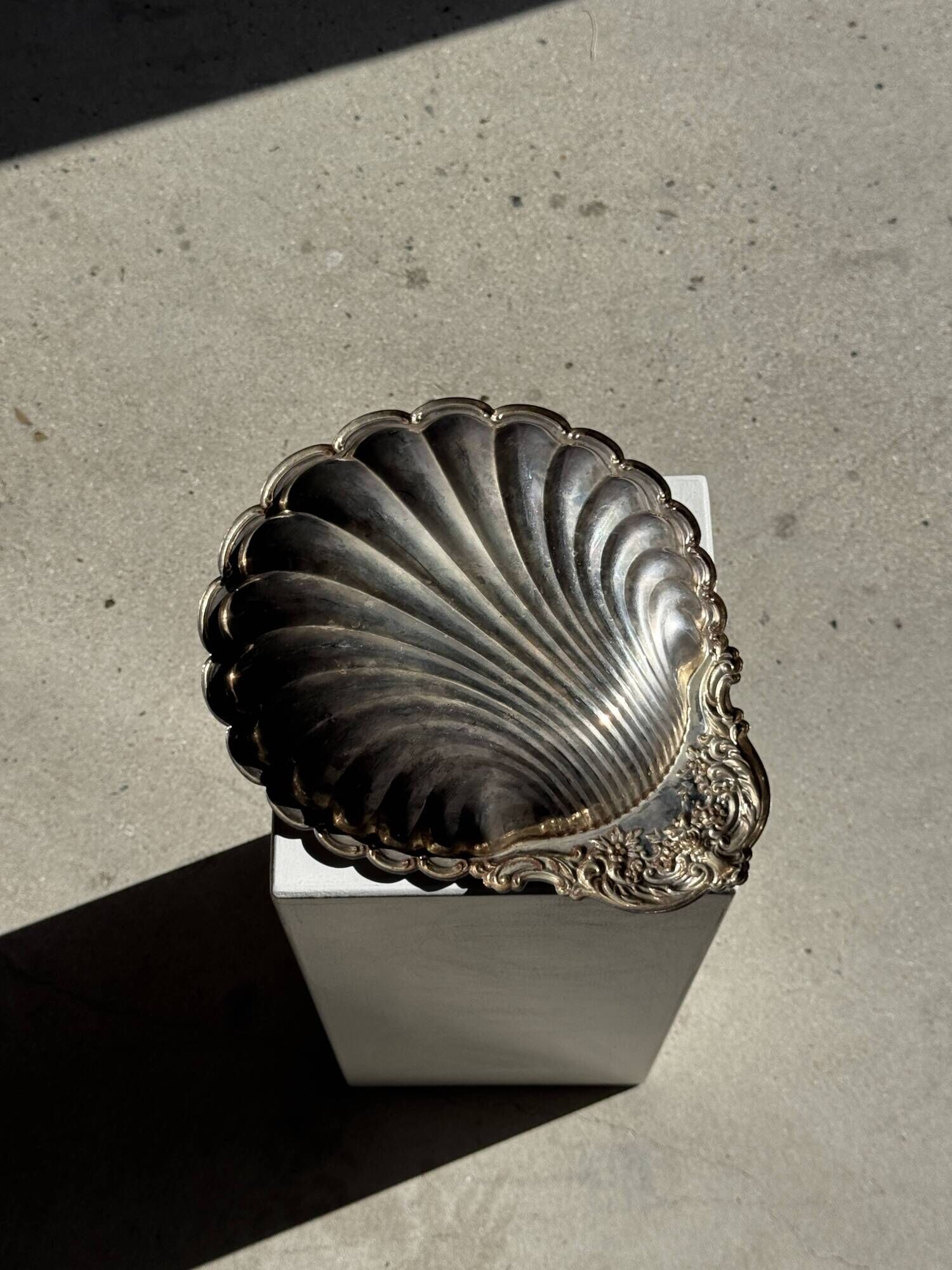 Large antique silver-plated bowl in the shape of a shell.