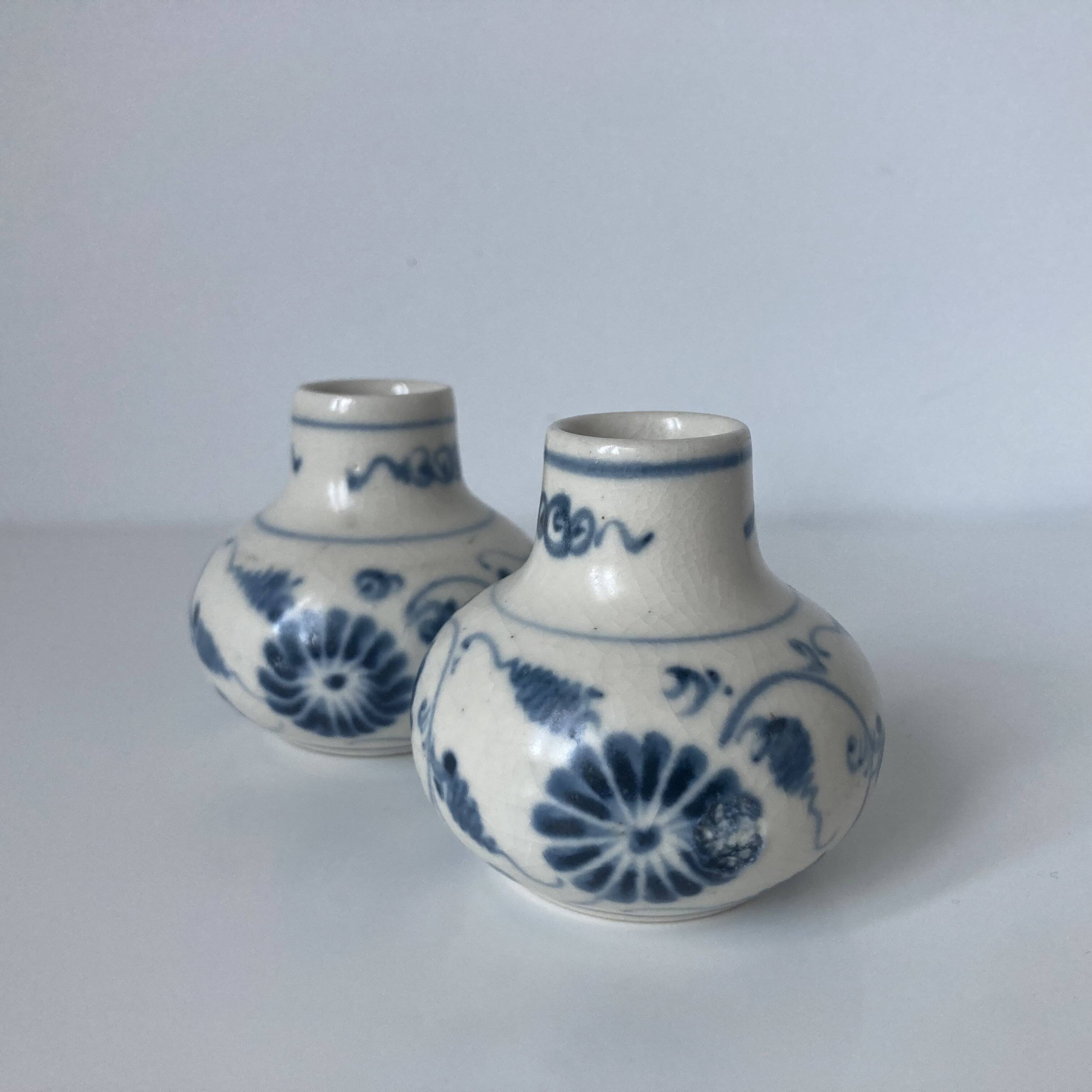 Pair of miniature blue and white Vietnamese ceramic vases with floral decoration.
