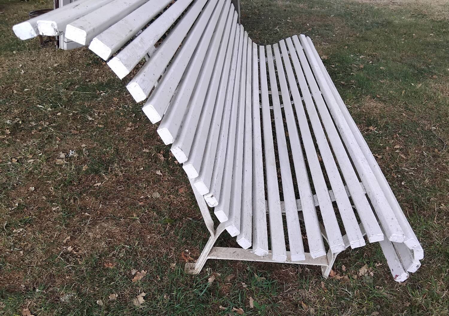 Old garden bench with metal legs and wooden slats